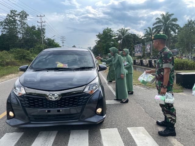 Personel dan Persit Kompi Senapan B Sanggau membagikan ratusan paket takjil gratis untuk masyarakat sekitar dan pengendara yang melintas, Sabtu (23/3). Foto: pek